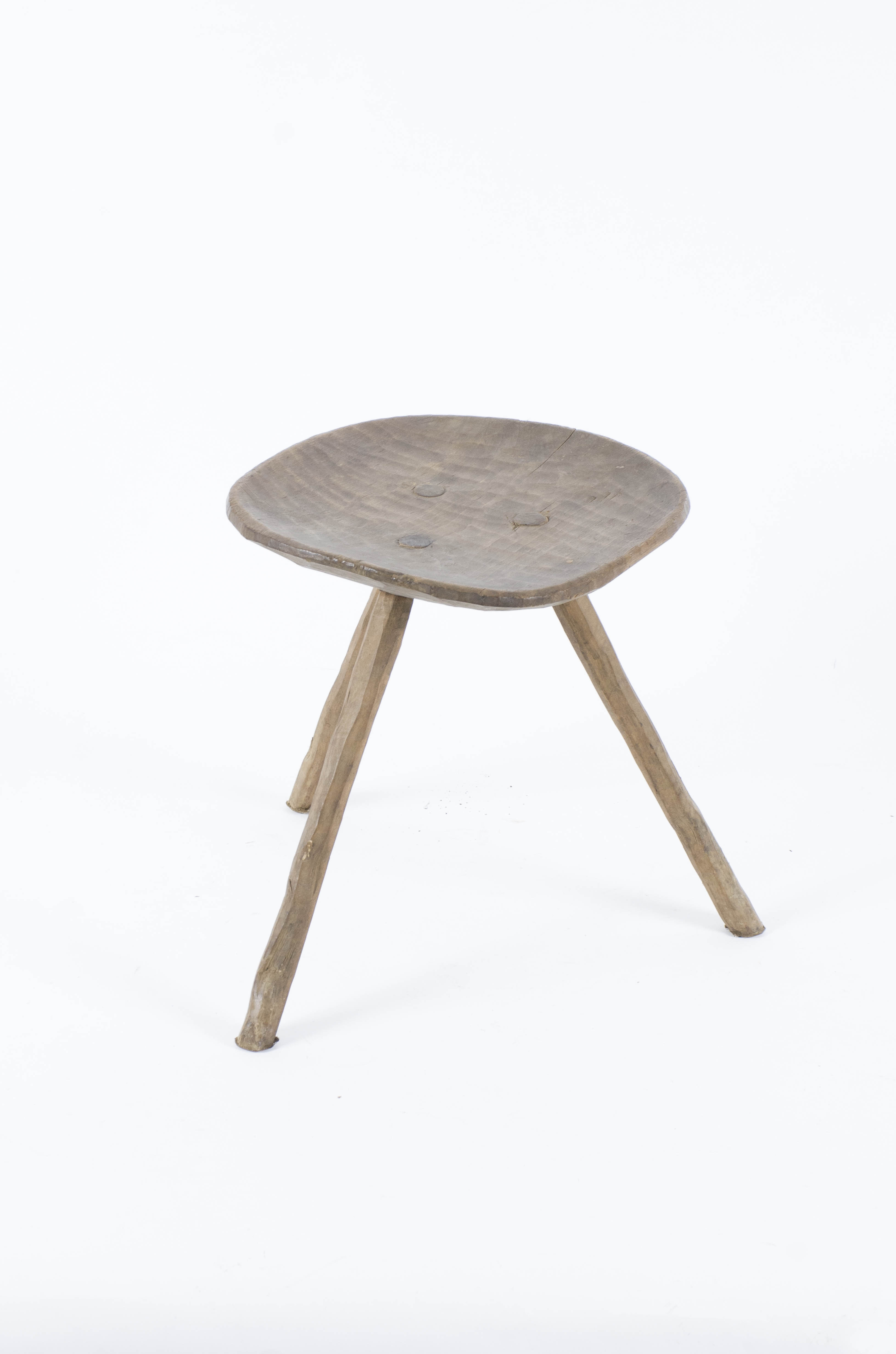 Piesă de mobilier formată dintr-o placă circulară ușor adâncită ce formează șezutul în care sunt fixate trei picioare rotunde. Cromatică: culoarea lemnului natur.
