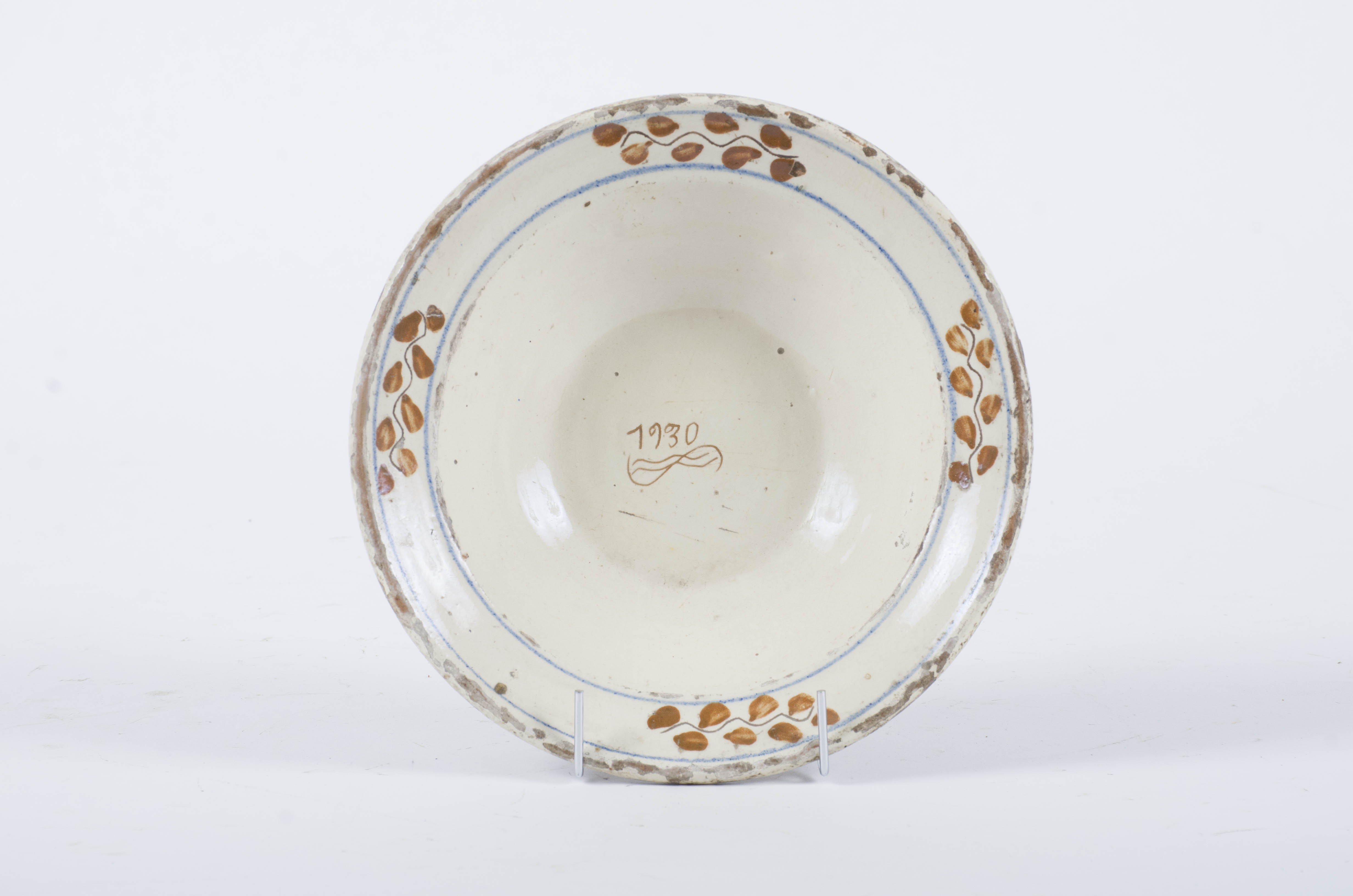Vasul ceramic este de formă circulară, adâncit, cu pereții evazați. Prezintă decor amplasat pe buza vasului cu motive geometrice și florale. Motivele florale sunt plasate la distanțe egale între ele în interiorul a două cercuri concentrice. Central este trecut anul ”1930” și motive curbilinii. Cromatică: fond: alb-crem; motive: maro; albastru.