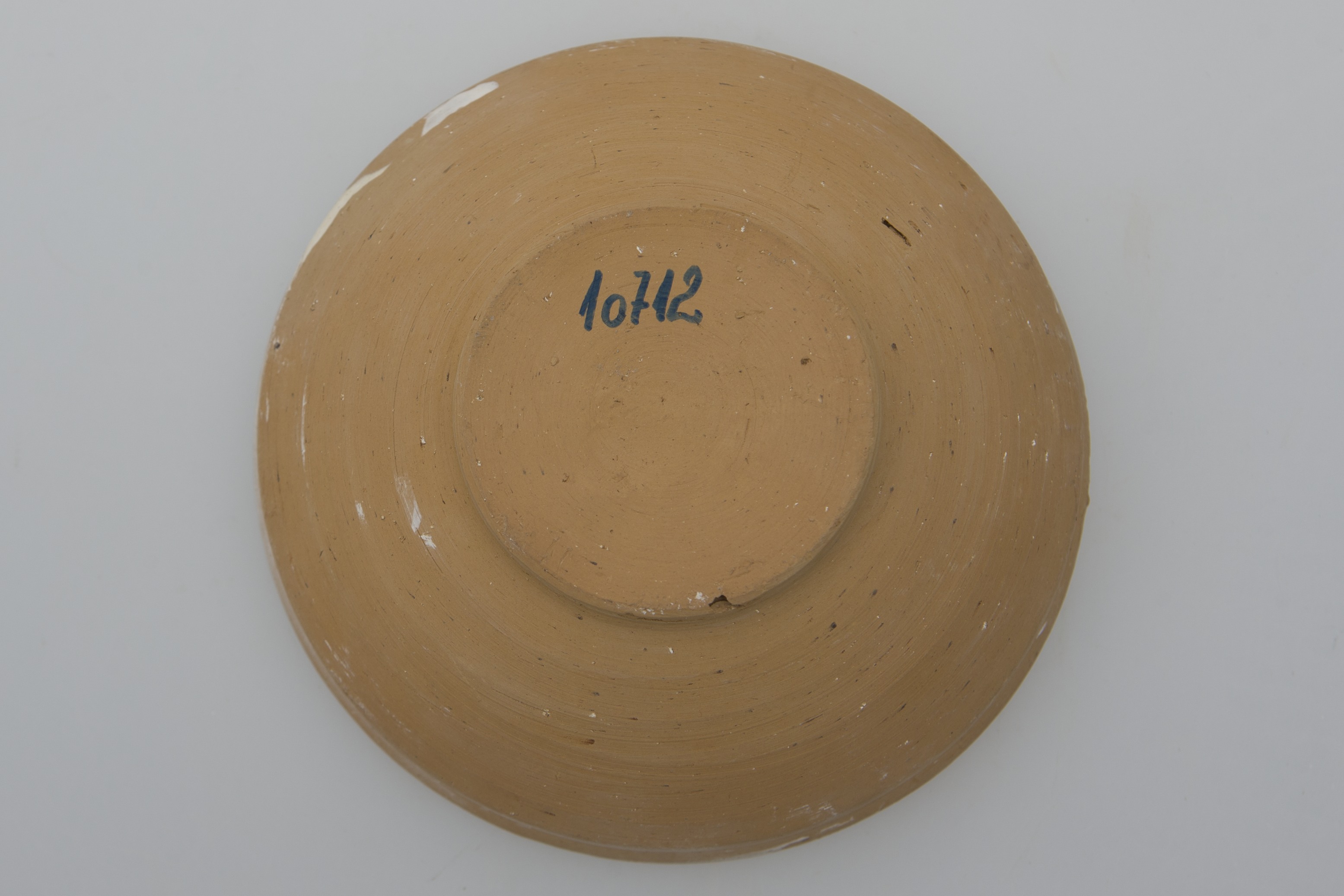 Vas de uz casnic, ceramic, de formă circulară, cu profil tronconic, ușor adâncit și buza rotunjită. Acesta este nesmălțuit și angobat. Obiectul prezintă decorații geometrice și florale pe întreaga suprafață interioară a vasului, realizate prin jirăvire cu gaița și prin pictare cu cornul. Strachina este ornamentată pe pereți cu o stea cu multe colțuri, intercalată cu flori stilizate și separată de restul vasului cu un cerc maro. În zona gurii, tot la interior, farfuria prezintă linii circulare, maro. Pe buză, este pictată o linie ondulată. Fundul vasului este nedecorat. Cromatică: fond alb; motive: negru, gri, maro deschis, maro închis.